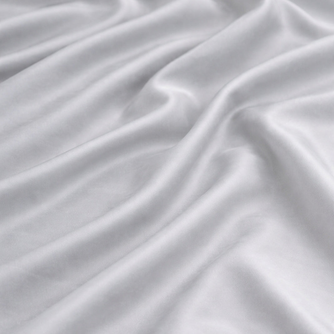 Close-up of grey 100% bamboo viscose duvet cover fabric showing a silky finish