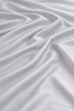 Close-up of grey 100% bamboo viscose duvet cover fabric showing a silky finish