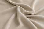 Close-up of beige bamboo duvet cover fabric showing a silky sateen weave and soft drape.