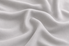 Close-up of silky smooth white bamboo fabric showing the soft texture of Pebble & Loom bedding