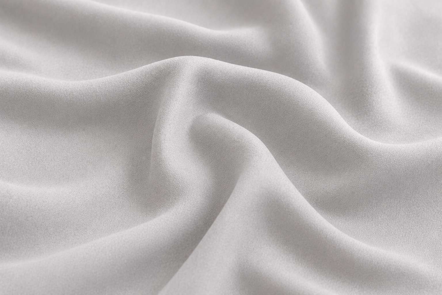 Close-up of silky smooth white bamboo fabric showing the soft texture of Pebble & Loom bedding