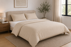 Cream bamboo duvet cover set on an upholstered bed in a bright airy bedroom — Pebble & Loom
