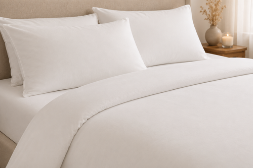 White bamboo duvet set on a bed with pillowcases — luxury bamboo bedding by Pebble & Loom