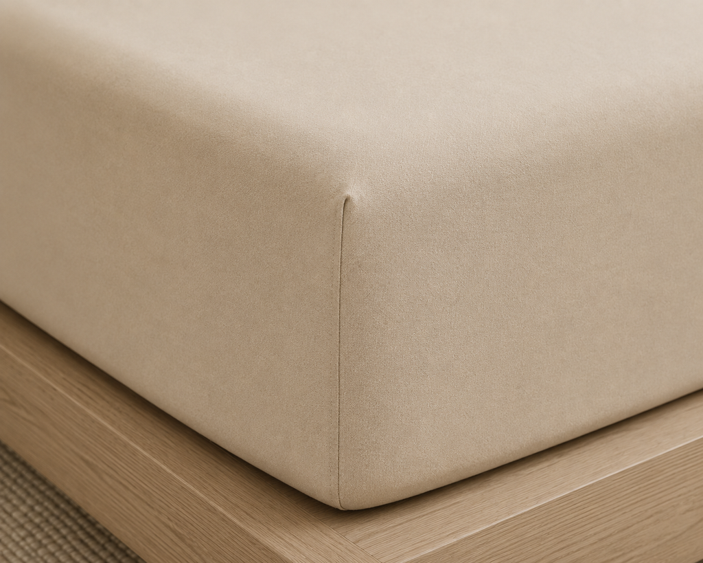 
close up corner of beige bamboo fitted bedsheet
