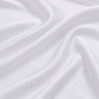 Close-up of silky white bamboo fabric with a soft sateen sheen, premium bamboo bed linen texture.